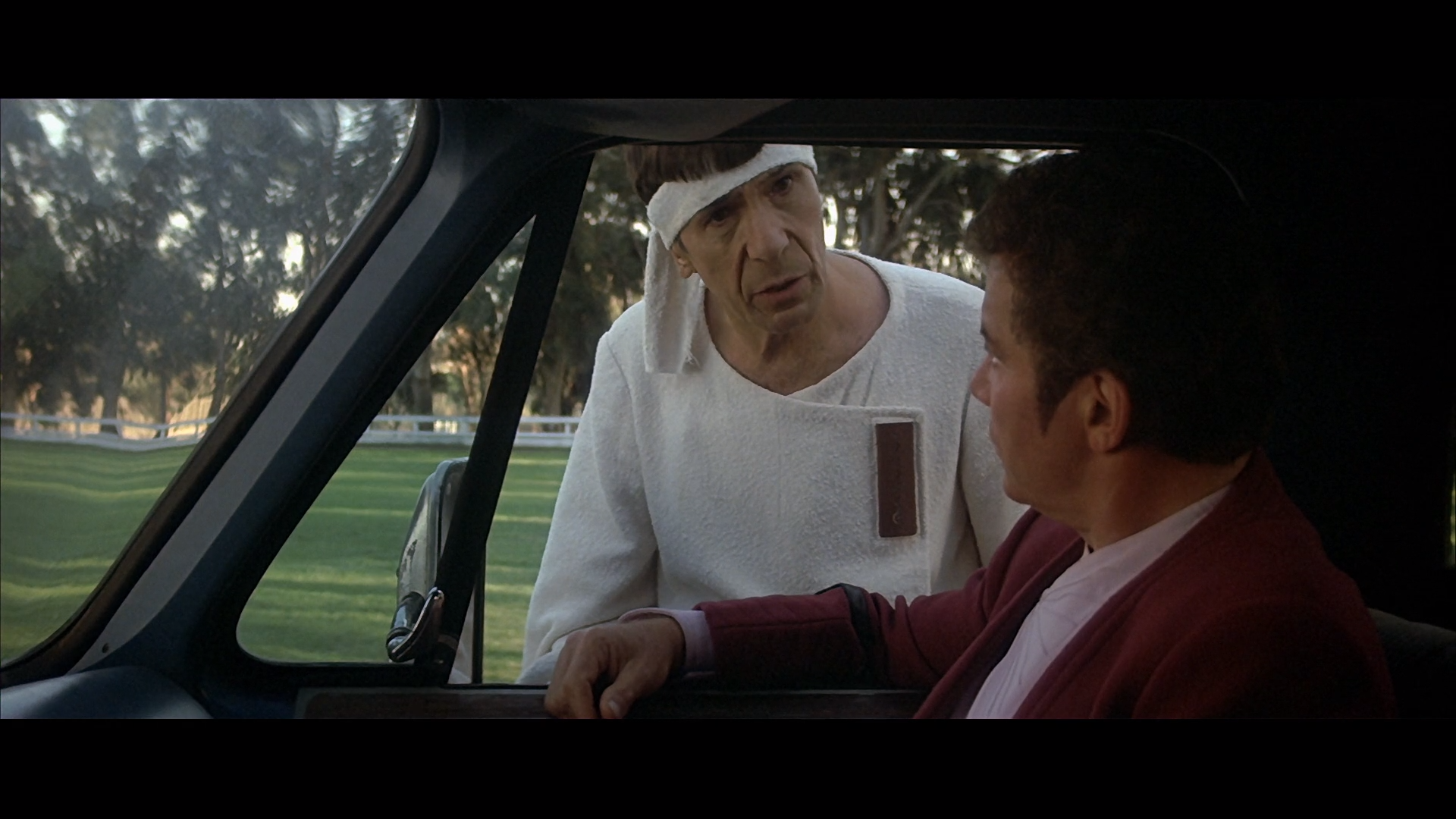 A shot of Spock standing next to Gillian's truck on the passenger side talking to Gillian who is off-camera behind the wheel.  Kirk is  sitting in the passenger seat looking at Spock.  They are in Golden Gate Park.