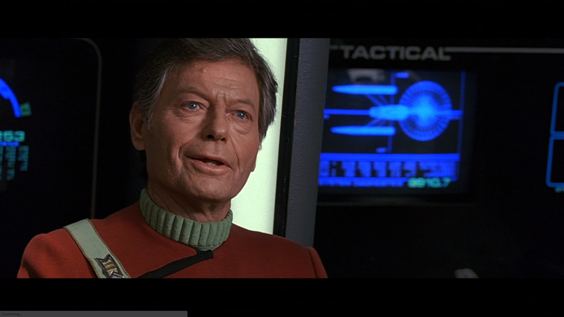 A close-up shot of Bones on the bridge of the Enterprise looking at the viewscreen (which shows the Excelsior departing).