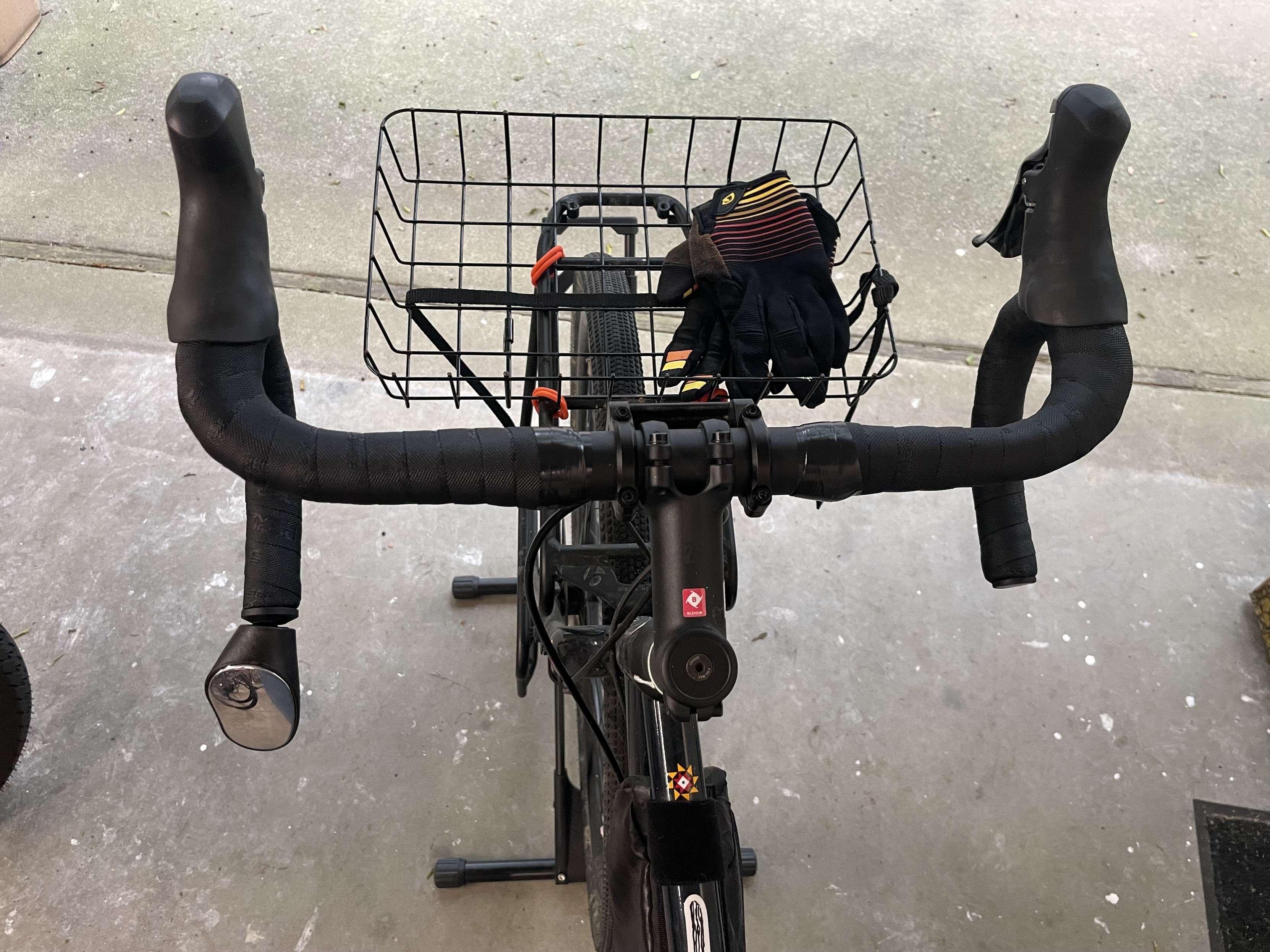 top down view of freshly wrapped handlebars. there’s a mirror on the left bar end and a basket up front.