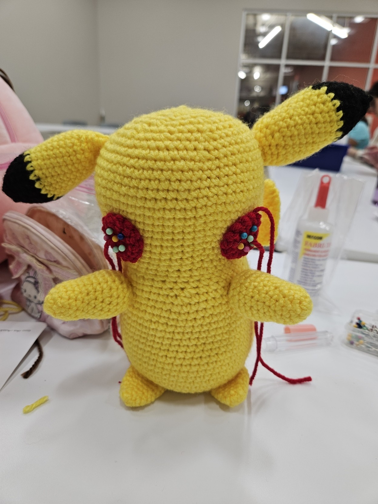 Front side of Pikachu. All parts are sown on other than his Cheeks which are pinned to his face. He also does not have his eyes, nose, or mouth yet.