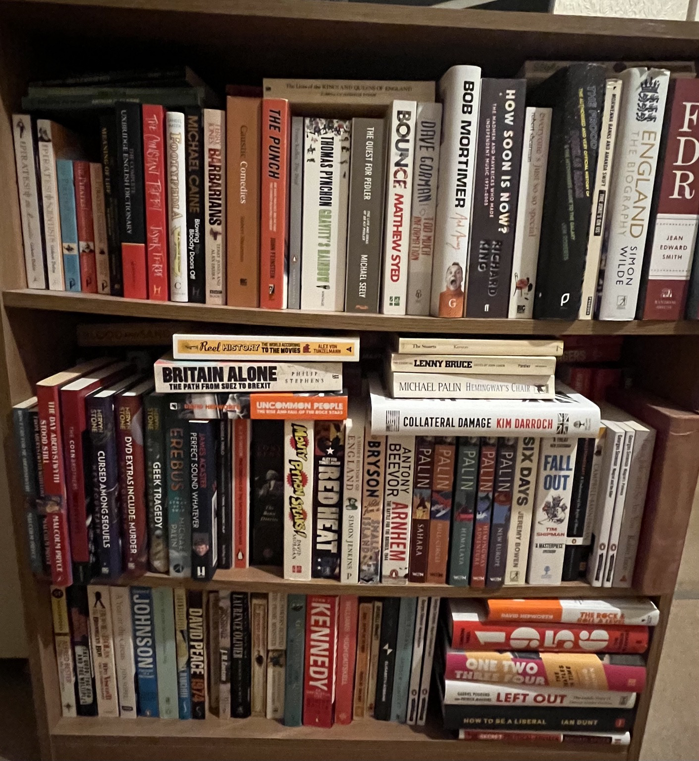 Slightly messy shelves of books including a selection of Michael Palin books