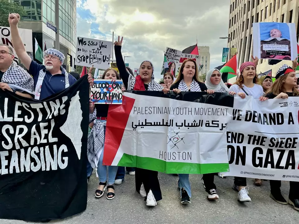 Palestinian protestors march in Downtown Houston to call for a cease-fire in the West Bank and Gaza.