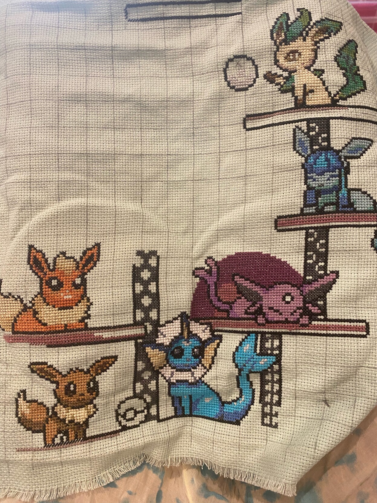 Unfinished cross stitch of eevee’s evolutions 