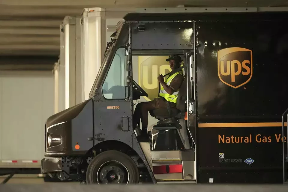 FILE - A UPS driver puts his seat belt on before driving off as UPS workers hold a rally in downtown Los Angeles as a national strike deadline nears on Wednesday, July 19, 2023. UPS has reached a contract agreement with its 340,000-person strong union Tuesday, July 25, 2023, averting a strike that had the potential to disrupt logistics nationwide for businesses and households alike.
