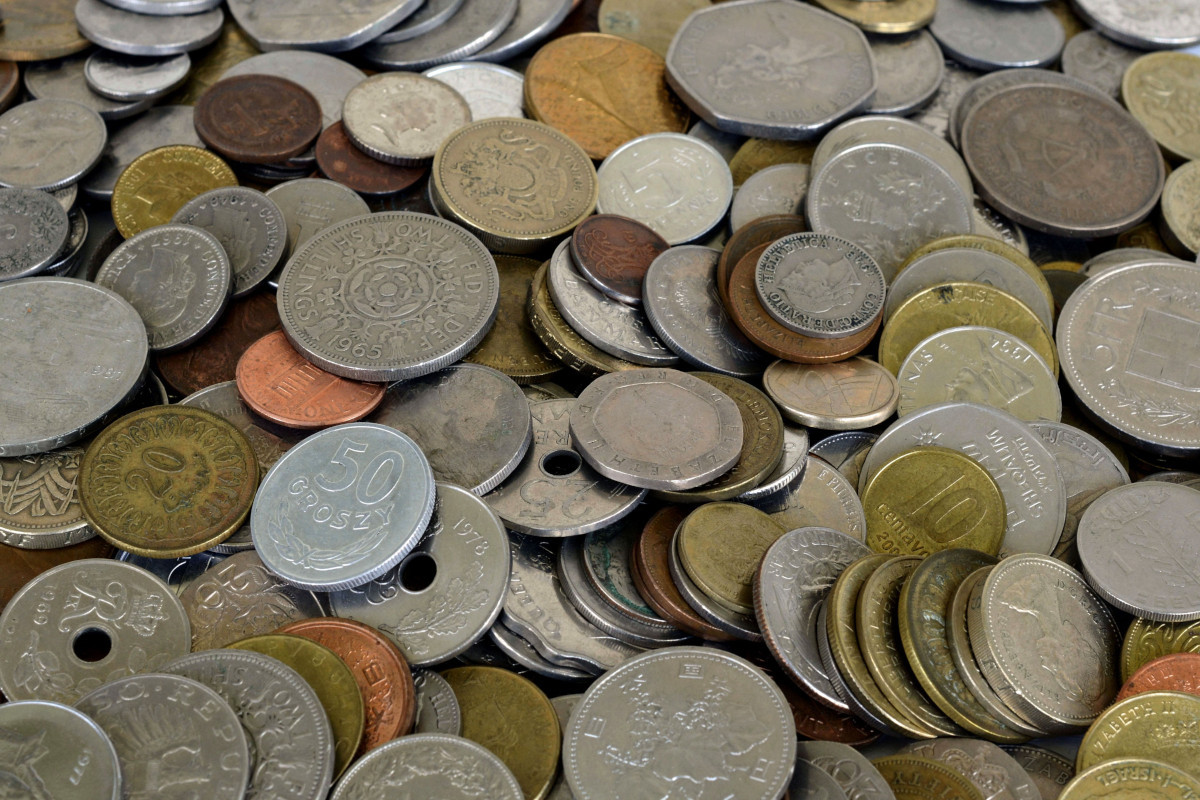 A pile of assorted coins from many countries.