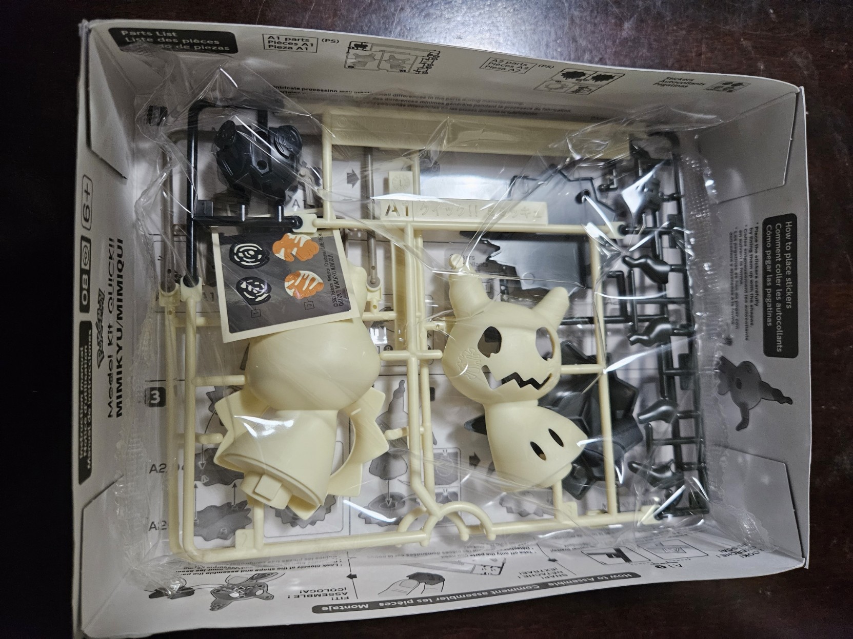 The open box of the model kit shows all its packaged pieces.